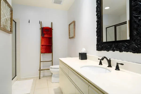 a bathroom with a sink toilet and a mirror