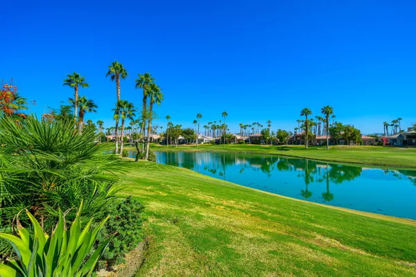 a view of a lake with a house in the background