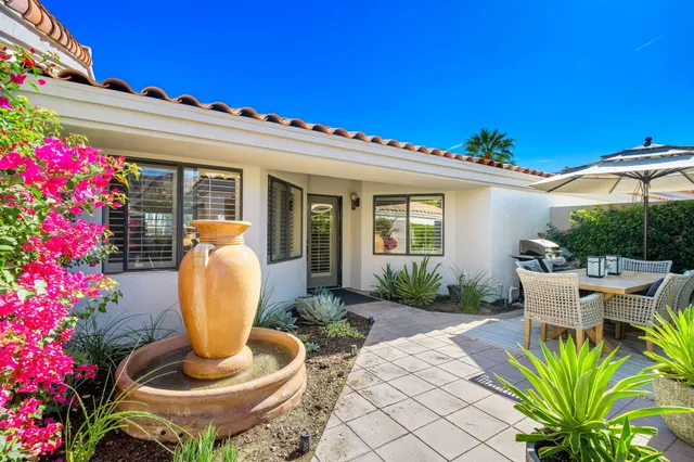 a view of a patio with table and chairs and potted plants