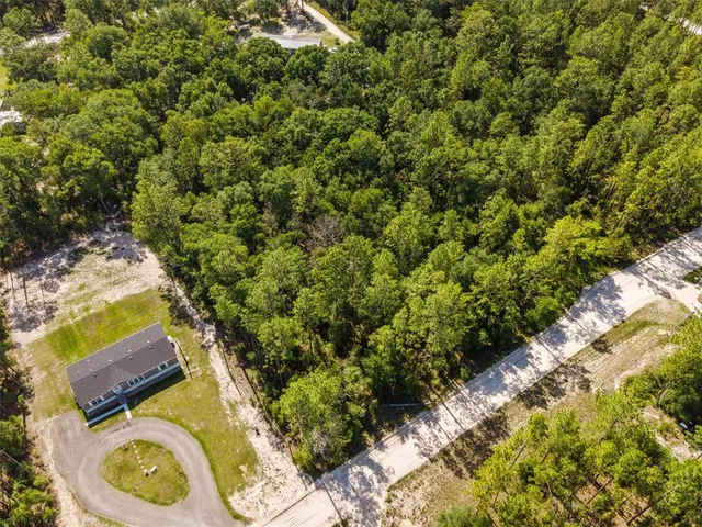 view of a wooden house with a yard