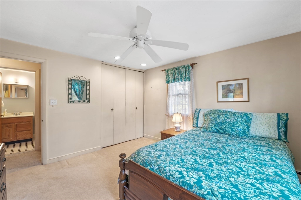 68 Preston Street, Unit 9D Wakefield, MA 01880 - Photo 16 of 29 a bedroom with a large bed and a chandelier
