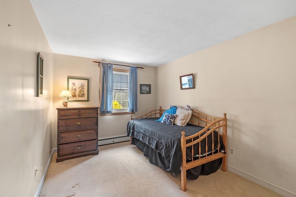 68 Preston Street, Unit 9D Wakefield, MA 01880 - Photo 17 of 29 a bedroom with a bed and a closet