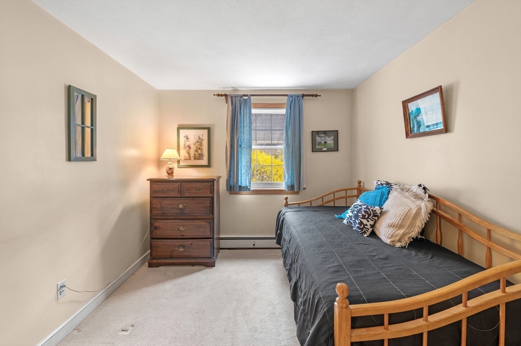 68 Preston Street, Unit 9D Wakefield, MA 01880 - Photo 18 of 29 a bed room with a bed and a window