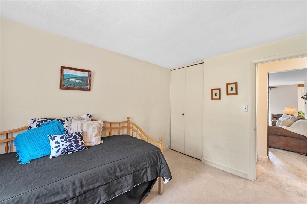 68 Preston Street, Unit 9D Wakefield, MA 01880 - Photo 19 of 29 a bedroom with a bed and a painting on the wall