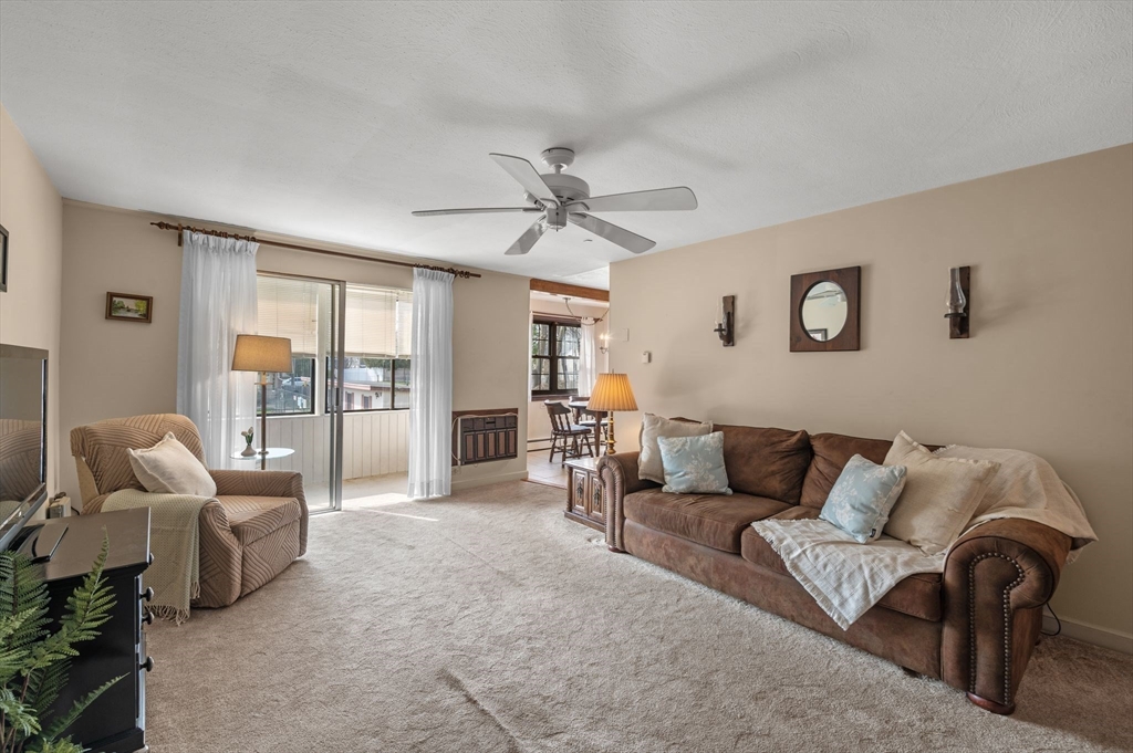 68 Preston Street, Unit 9D Wakefield, MA 01880 - Photo 2 of 29 a living room with furniture and a large window