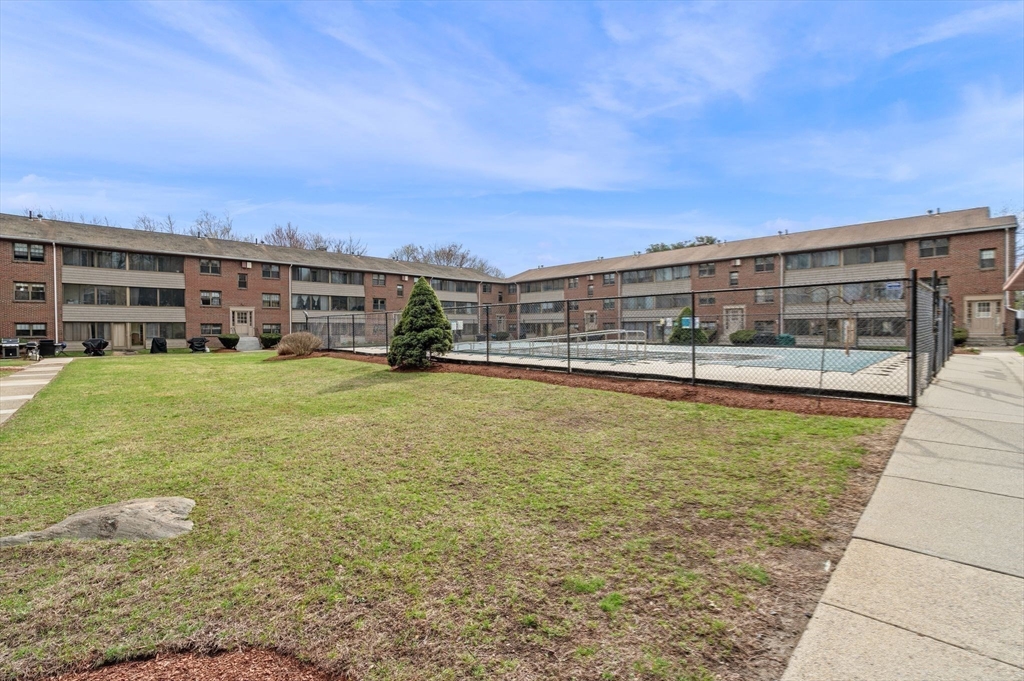 68 Preston Street, Unit 9D Wakefield, MA 01880 - Photo 26 of 29 a view of a swimming pool with an outdoor seating and a yard