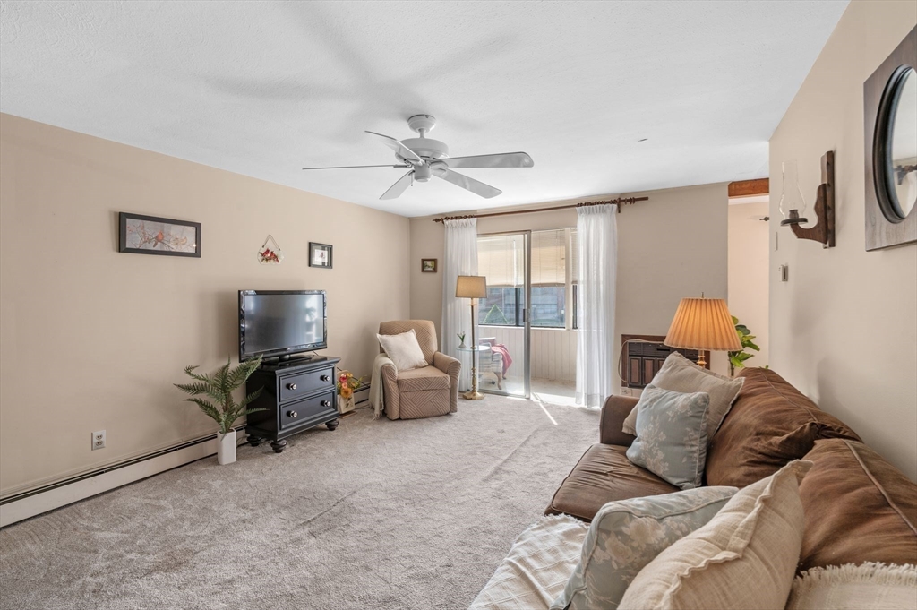 68 Preston Street, Unit 9D Wakefield, MA 01880 - Photo 4 of 29 a living room with furniture and a flat screen tv