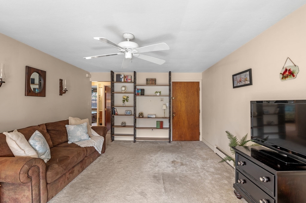 68 Preston Street, Unit 9D Wakefield, MA 01880 - Photo 5 of 29 a living room with furniture and a flat screen tv