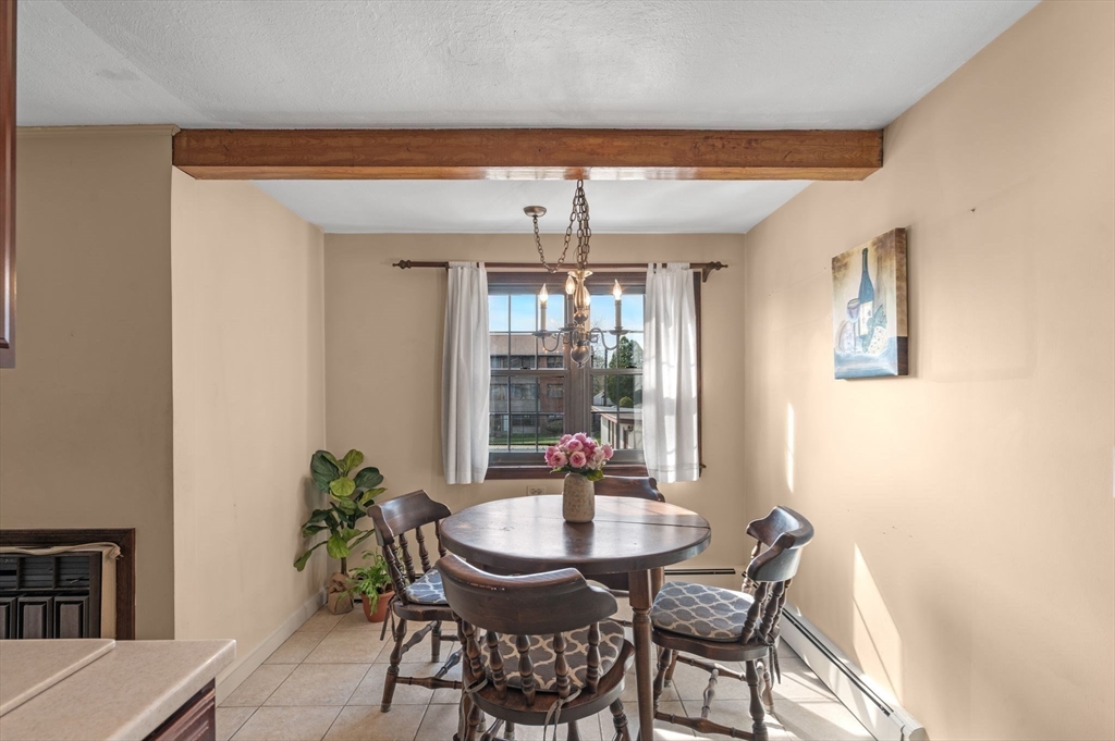 68 Preston Street, Unit 9D Wakefield, MA 01880 - Photo 8 of 29 a dining room with furniture and window