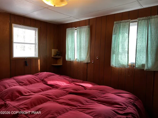 a bedroom with a bed and window