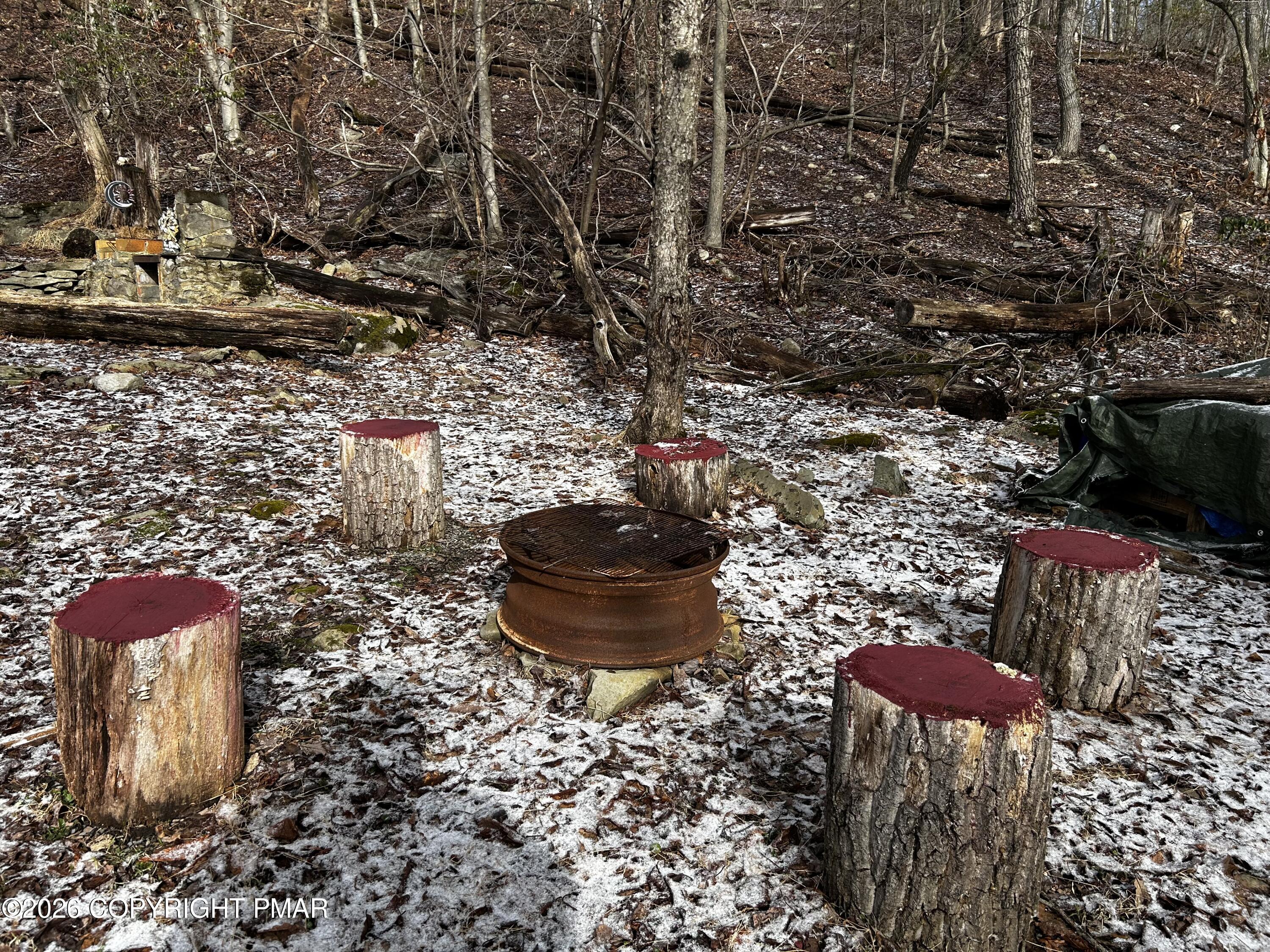 255 Buck Fever Trail Scotrun, PA 18355 - Photo 16 of 27 a view of a backyard with table and chairs and potted plants