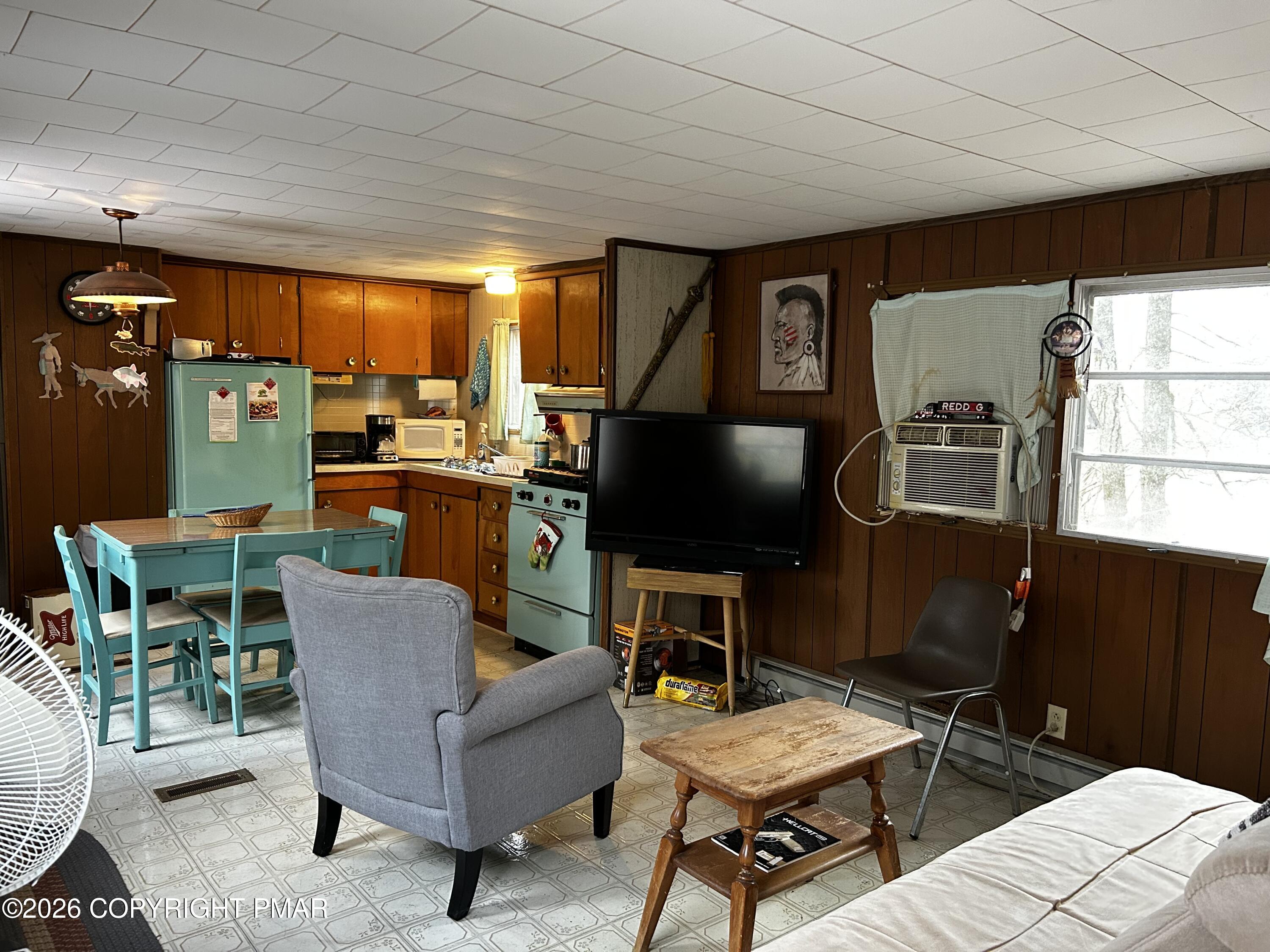 255 Buck Fever Trail Scotrun, PA 18355 - Photo 2 of 27 a living room with furniture a window and a flat screen tv