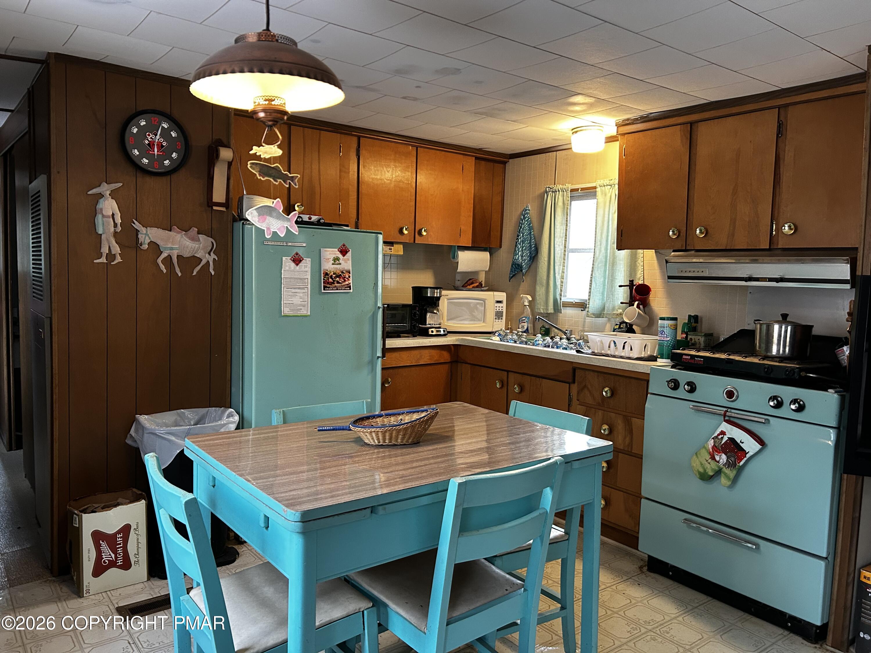 255 Buck Fever Trail Scotrun, PA 18355 - Photo 3 of 27 a kitchen that has a table chairs and a refrigerator