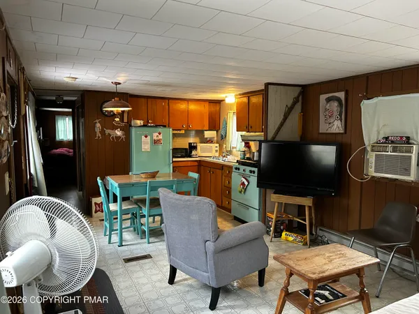 a living room with furniture a rug and a flat screen tv