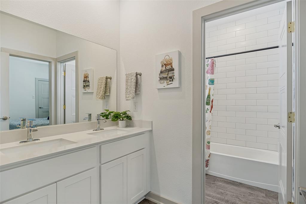 1650 Jessica Lane Allen, TX 75002 - Photo 15 of 25 a bathroom with a bathtub sink vanity and mirror