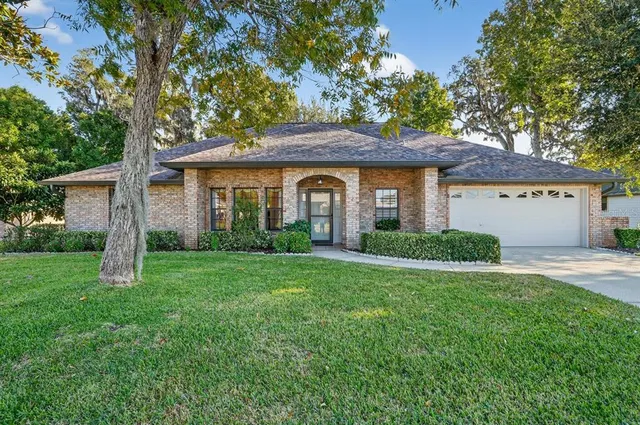 a front view of a house with a garden and yard