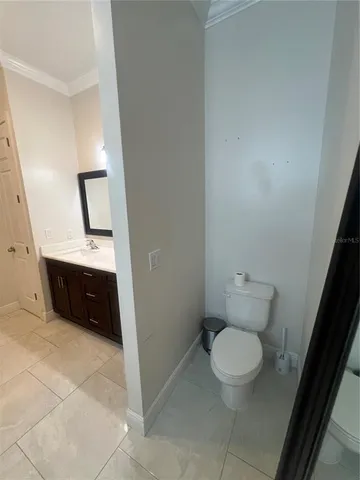 a bathroom with a toilet a sink and a mirror