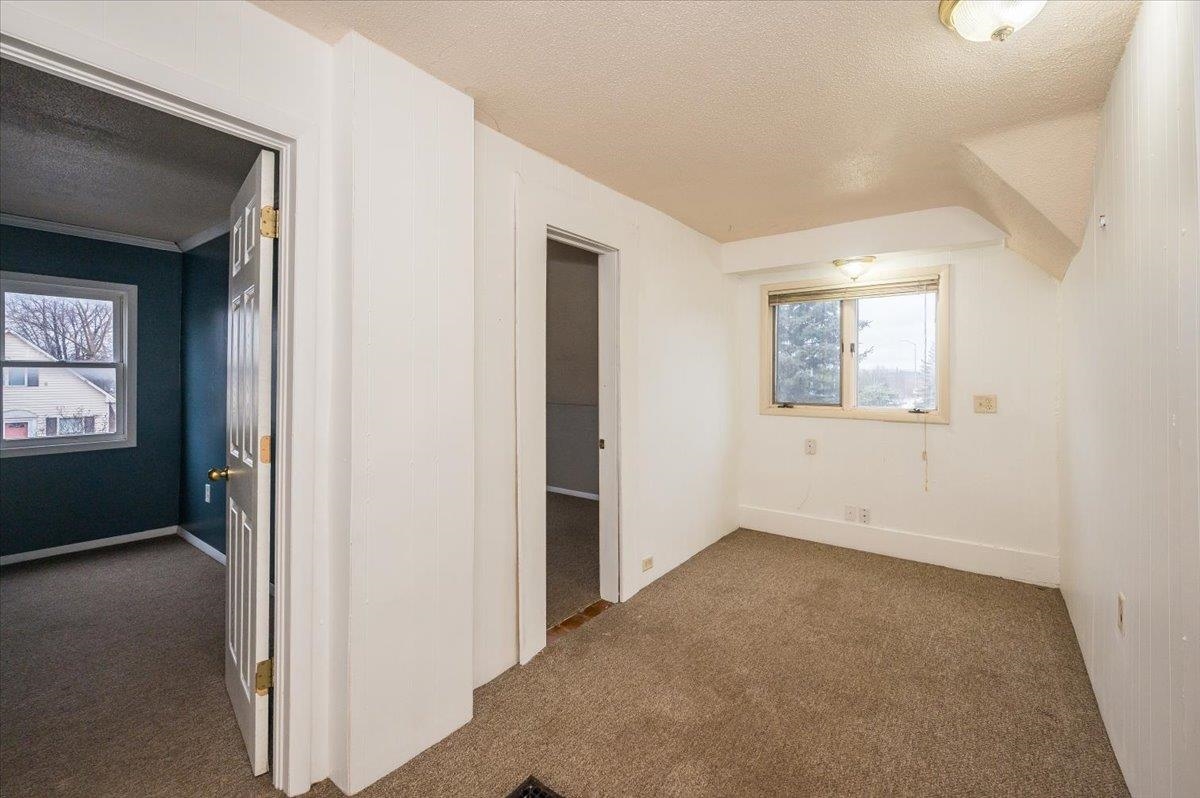 3701 East 2nd Street Superior, WI 54880 - Photo 11 of 25 Bonus room featuring a textured ceiling, dark carpet, and plenty of natural light