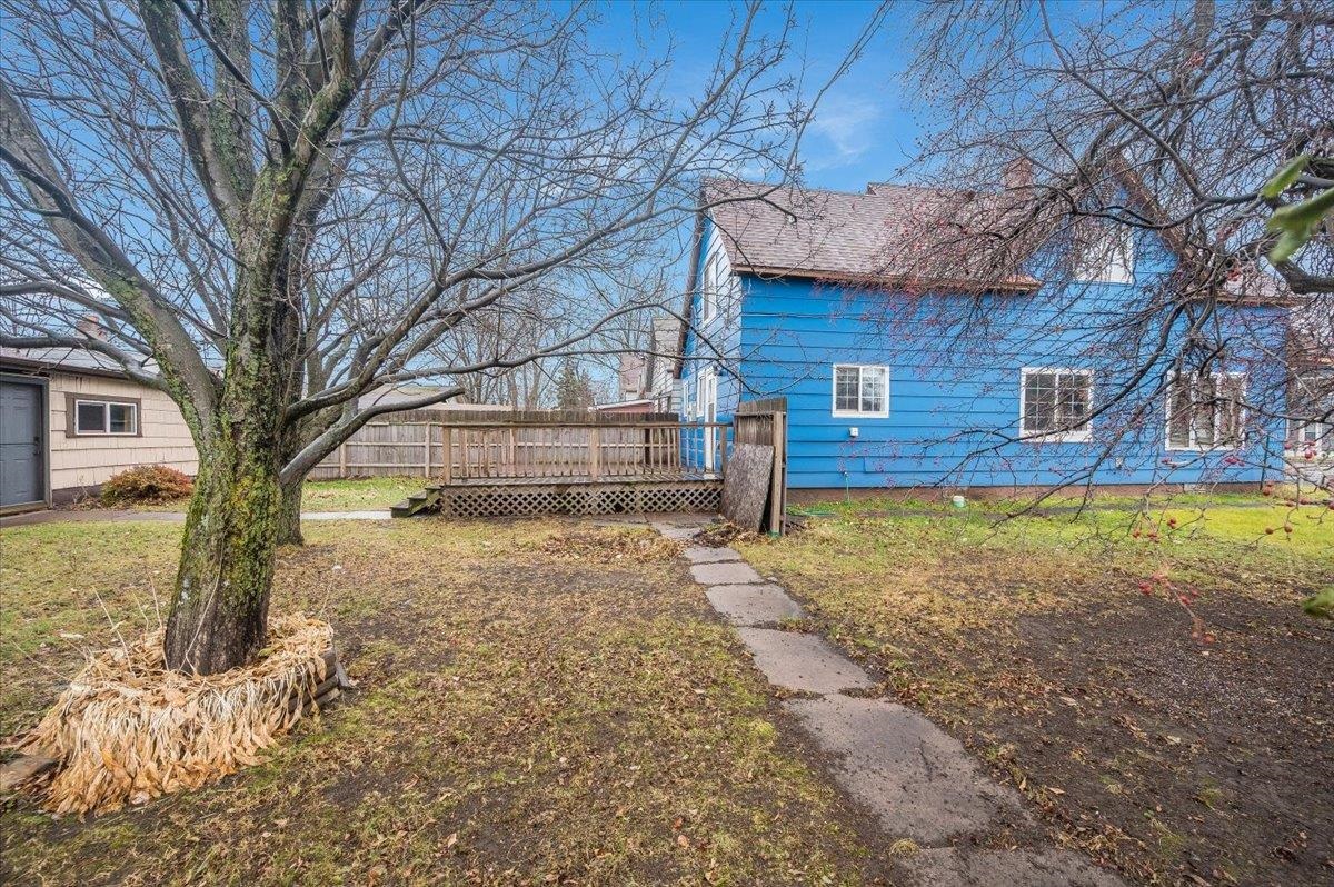 3701 East 2nd Street Superior, WI 54880 - Photo 20 of 25 View of home's exterior with a deck, a lawn, and a chimney