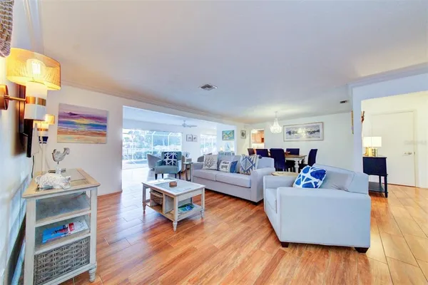 a living room with furniture and a wooden floor