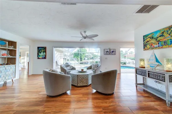 a living room with furniture window and wooden floor