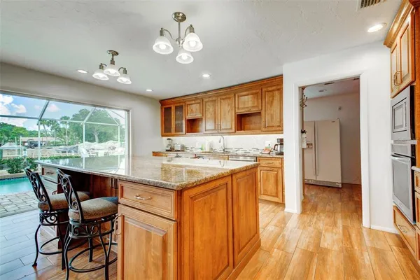 a large kitchen with a table and chairs