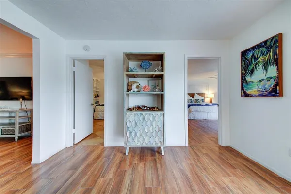 a empty room with wooden floor and closet