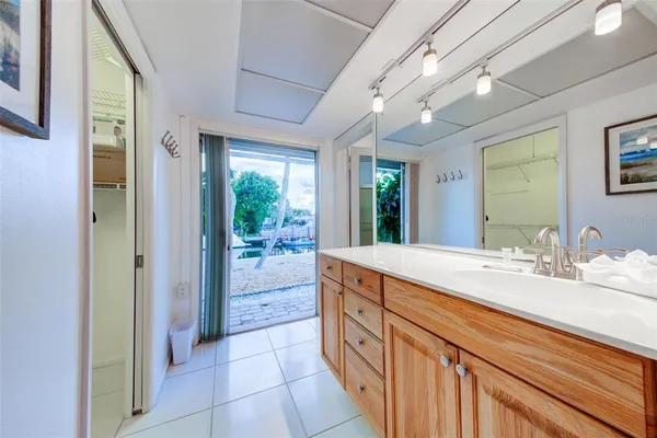 a bathroom with a granite countertop sink mirror and shower