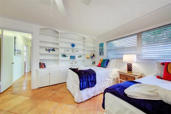 a bedroom with furniture and a wooden floor
