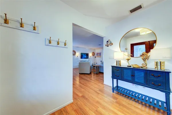 a view of living room with furniture and a mirror