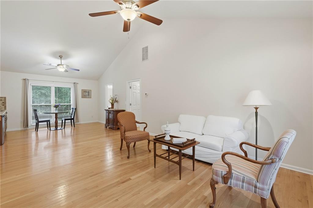 4891 Bill Cheek Road Auburn, GA 30011 - Photo 50 of 99 a living room with furniture and a wooden floor