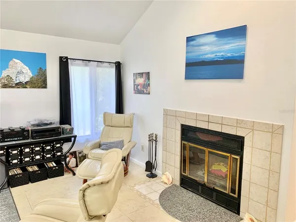 a living room with furniture a rug and white walls