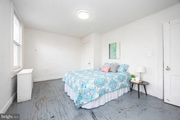 a bedroom with a bed and window