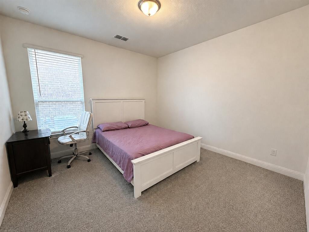 3598 Furrow Road Frisco, TX 75035 - Photo 12 of 14 a spacious bedroom with a bed and window