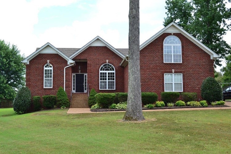 a front view of a house with a yard