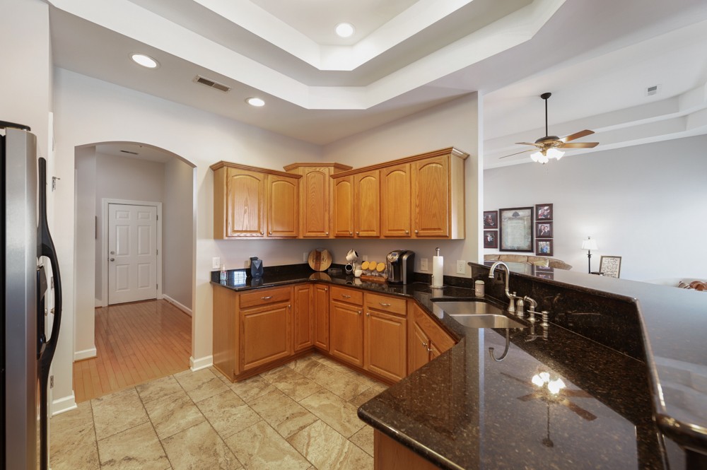 706 Deer Ridge Lane Lebanon, TN 37087 - Photo 12 of 29 a kitchen with granite countertop a stove a sink dishwasher a refrigerator and cabinets with wooden floor