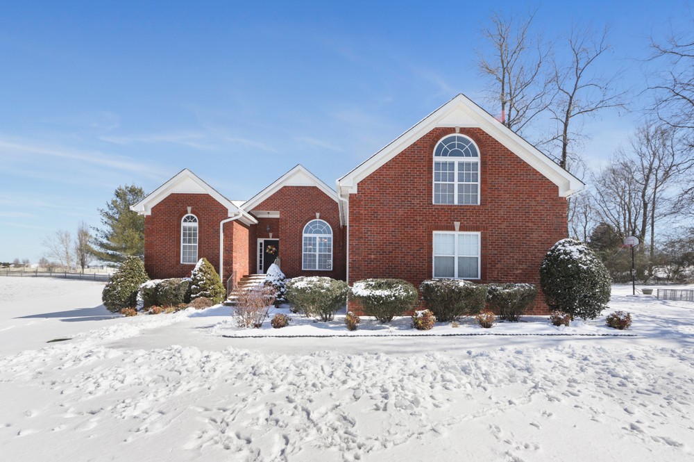 706 Deer Ridge Lane Lebanon, TN 37087 - Photo 28 of 29 a front view of a house with a yard covered in snow