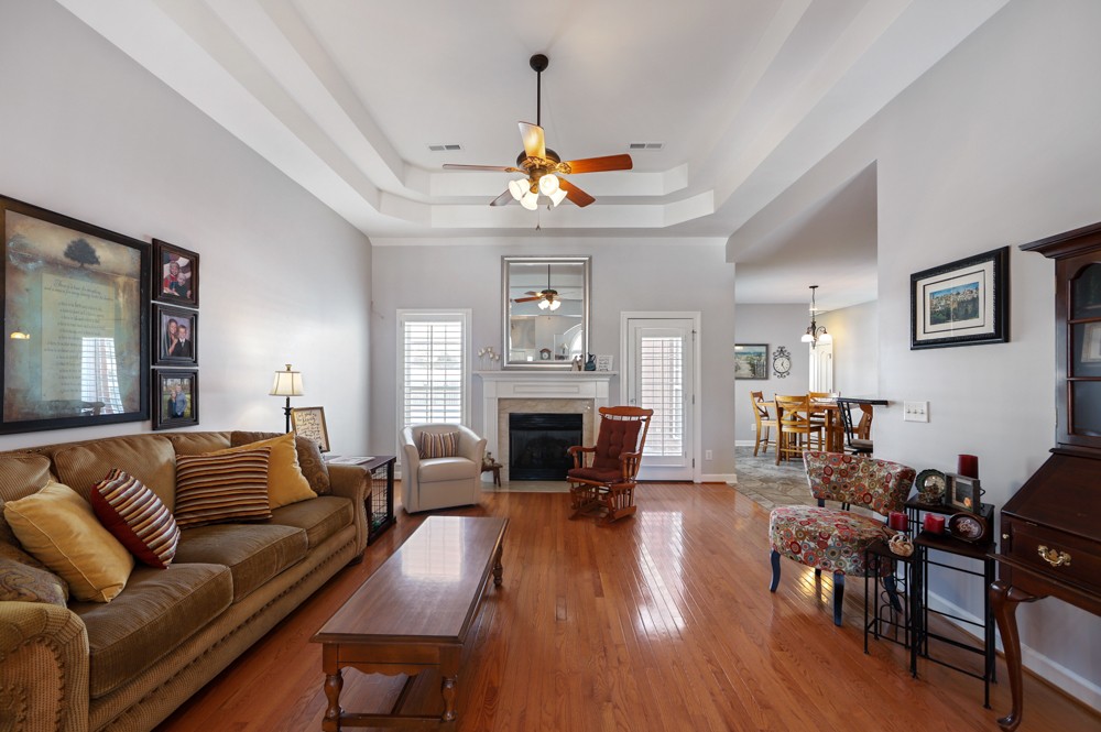 706 Deer Ridge Lane Lebanon, TN 37087 - Photo 6 of 29 a living room with furniture a fireplace and a chandelier
