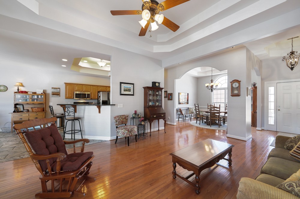 706 Deer Ridge Lane Lebanon, TN 37087 - Photo 8 of 29 a living room with furniture a chandelier and a dining room