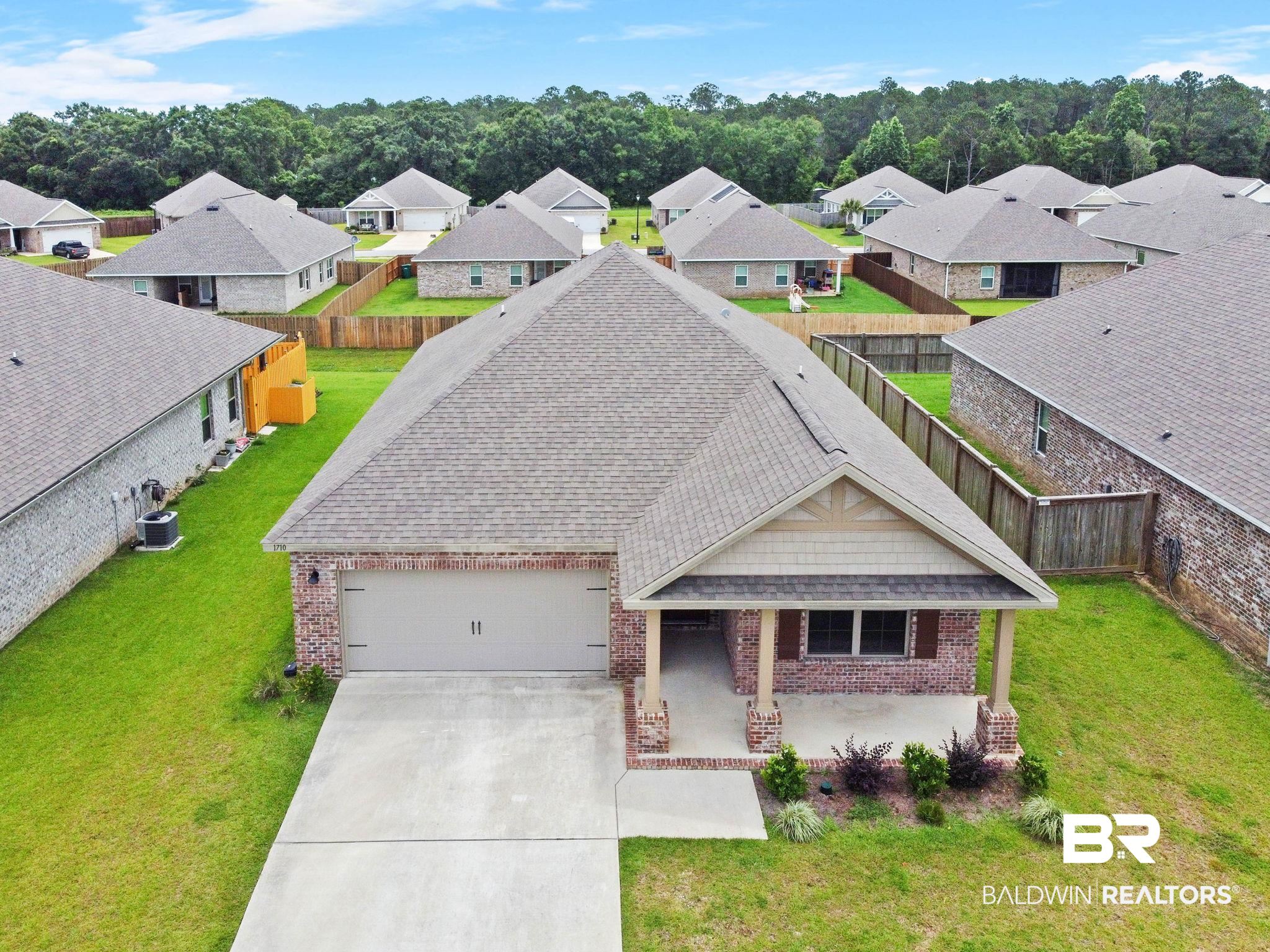 1710 Grouse Street Foley, AL 36535 - Photo 5 of 76 Single-story residence featuring a brick and shake exterior, a two-car garage, and a covered front porch