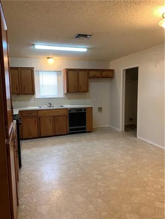 a large kitchen with cabinets and stainless steel appliances