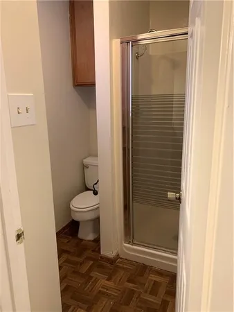 a bathroom with a toilet and a shower