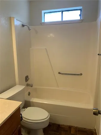a bathroom with a toilet and a bathtub