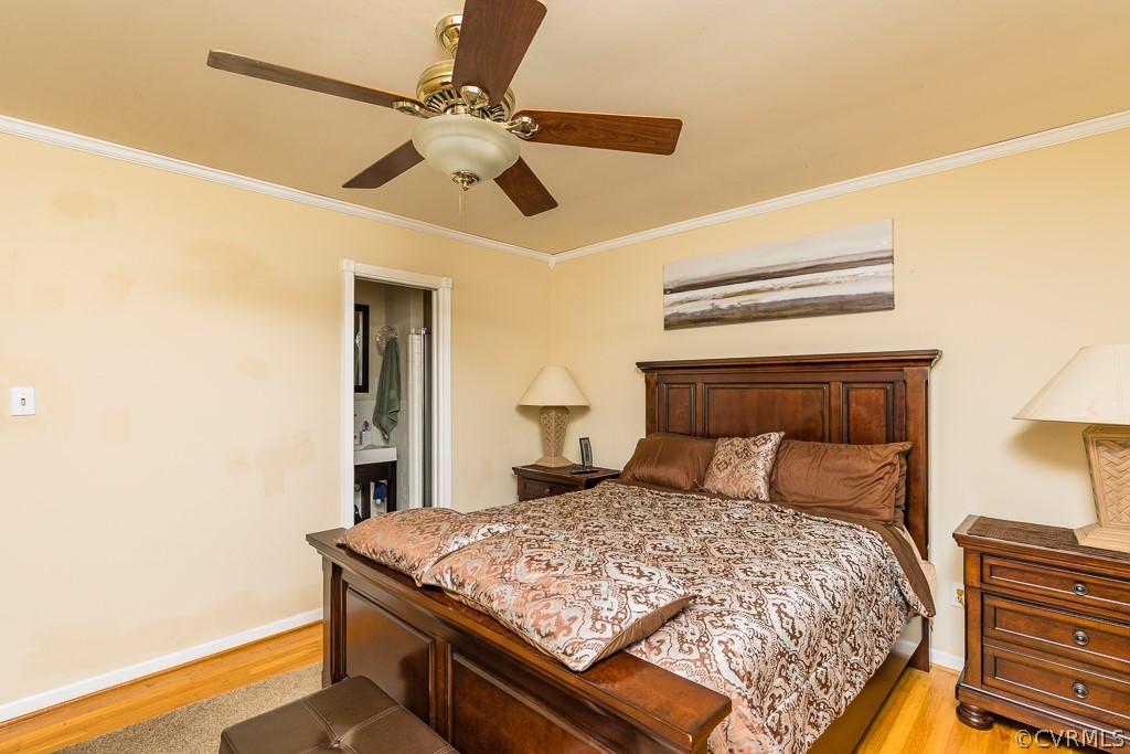 11301 Rolling Brook Road Chester, VA 23831 - Photo 28 of 49 a bedroom with a bed and a chandelier