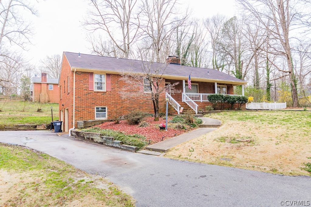 11301 Rolling Brook Road Chester, VA 23831 - Photo 47 of 49 a front view of a house with a yard and garage