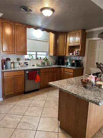 a kitchen with stainless steel appliances granite countertop a sink stove and cabinets