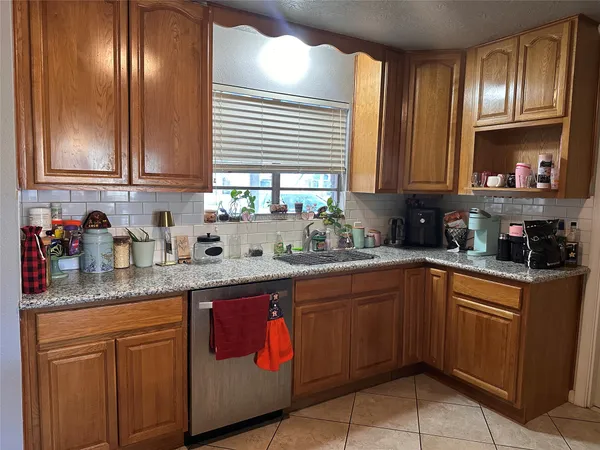 a kitchen with stainless steel appliances granite countertop a sink and cabinets