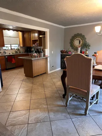 a living room with couches a dining table and kitchen view