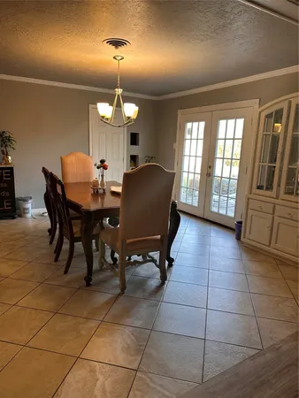 a view of a dining room with furniture and chandelier