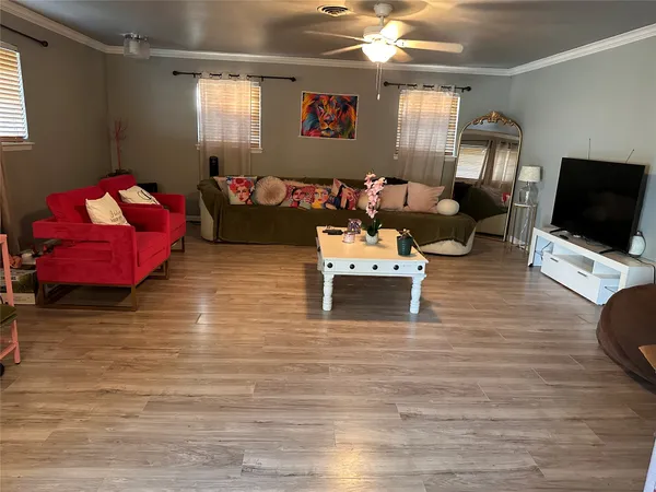 a living room with furniture and a flat screen tv